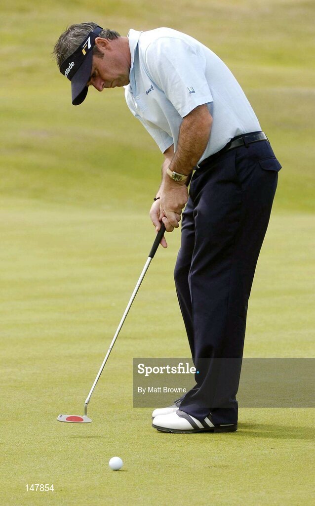 21 July 2004; Paul McGinley watches his putt on the 4th green during the first round. Nissan Irish Open Golf Championship, County Louth Golf Club, Baltray, Co. Louth. Picture credit; Matt Browne / SPORTSFILE
