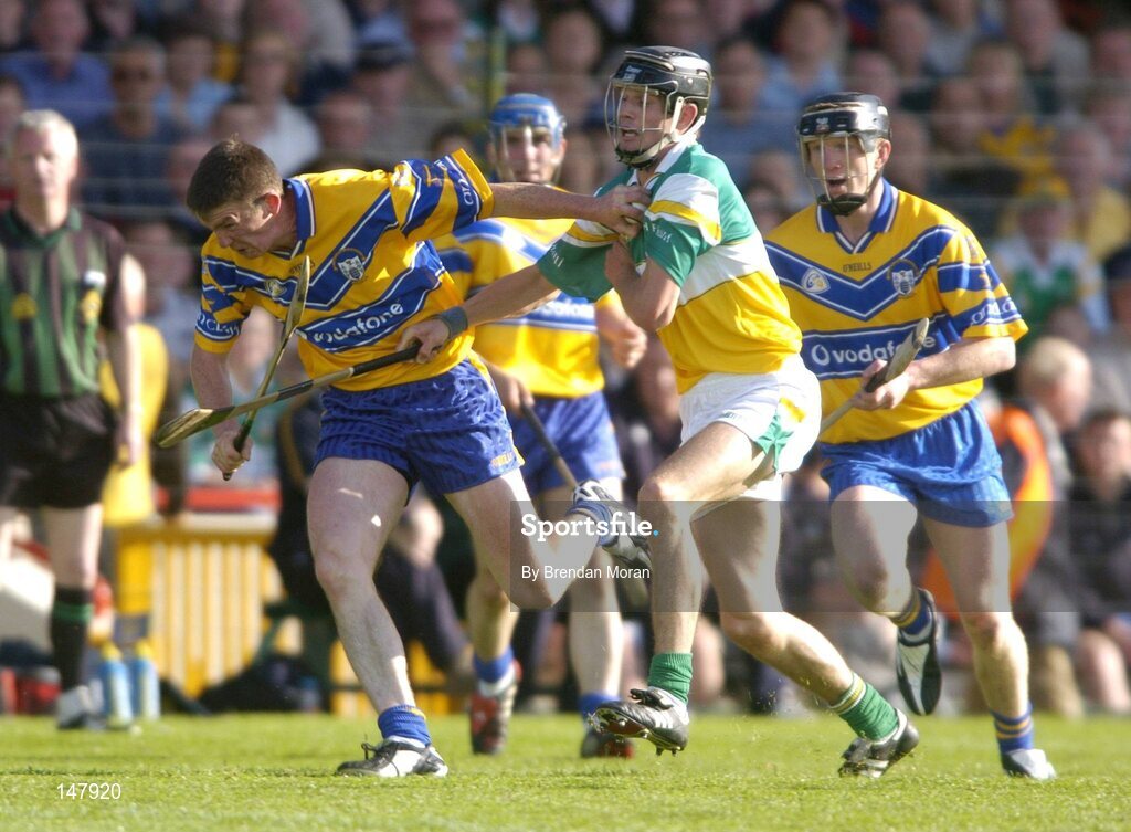 17 July 2004; Diarmuid McMahon, Clare, in action against Rory Hanniffy, Offaly, as team-mate Niall Giilligan, right, looks on . Guinness Senior Hurling Championship Qualifier, Round 3, Clare v Offaly, Gaelic Grounds, Limerick. Picture credit; Brendan Moran / SPORTSFILE
