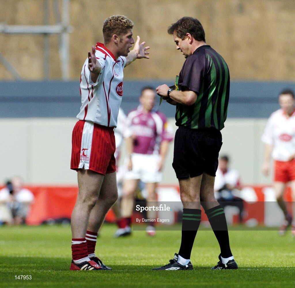 17 July 2004; Kevin Hughes, Tyrone, pleads his innocence to referee Michael Monahan. Bank of Ireland Senior Football Championship Qualifier, Round 3, Tyrone v Galway, Croke Park, Dublin. Picture credit; Damien Eagers / SPORTSFILE