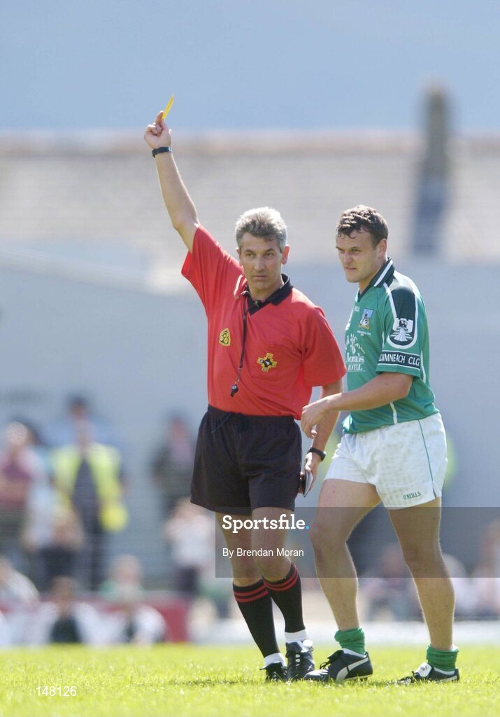 18 July 2004; Limerick's Jason Stokes is shown a yellow card by referee Mick Curley. Bank of Ireland Munster Senior Football Championship Final Replay, Kerry v Limerick, Fitzgerald Stadium, Killarney, Co. Kerry. Picture credit; Brendan Moran / SPORTSFILE