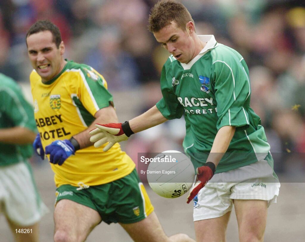 24 July 2004; Fermanagh's Eamon Maguire prepares to shoot for his sdes opening goal, despite the attentions of Donegal's Shane Carr. Bank of Ireland Senior Football Championship Qualifier, Round 4, Fermanagh v Donegal, Tighernach's Park, Clones. Co. Monaghan. Picture credit; Damien Eagers / SPORTSFILE
