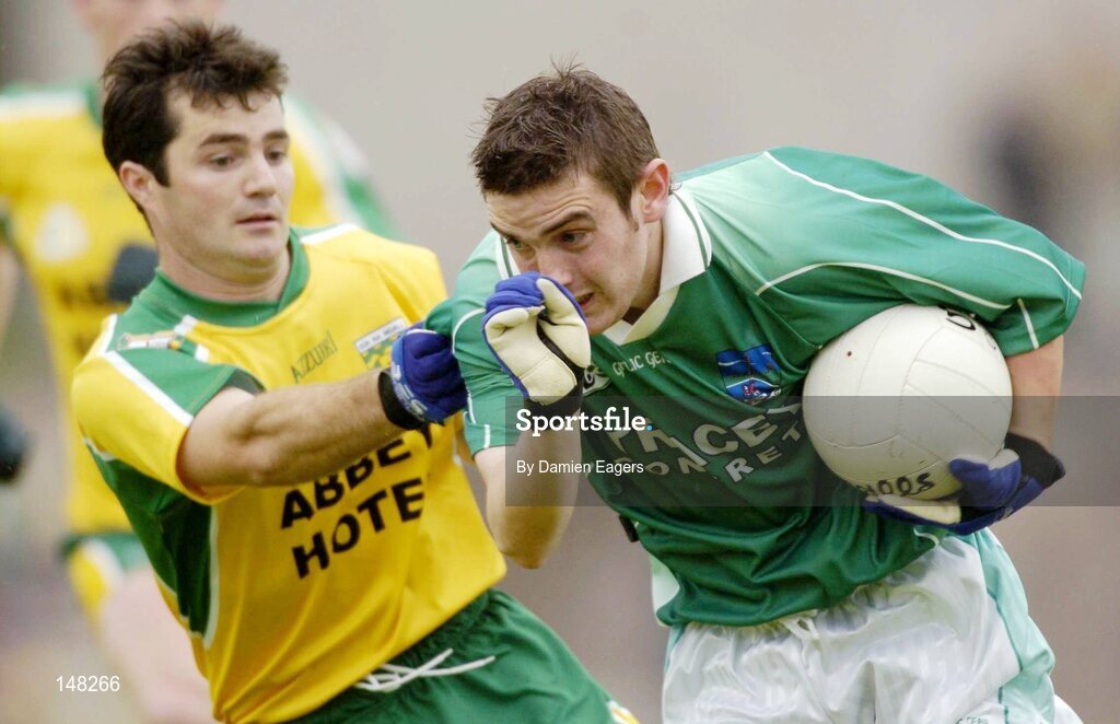 24 July 2004; Colm Bradley, Fermanagh, is tackled by Donegal's Niall McCready. Bank of Ireland Senior Football Championship Qualifier, Round 4, Fermanagh v Donegal, Tighernach's Park, Clones. Co. Monaghan. Picture credit; Damien Eagers / SPORTSFILE