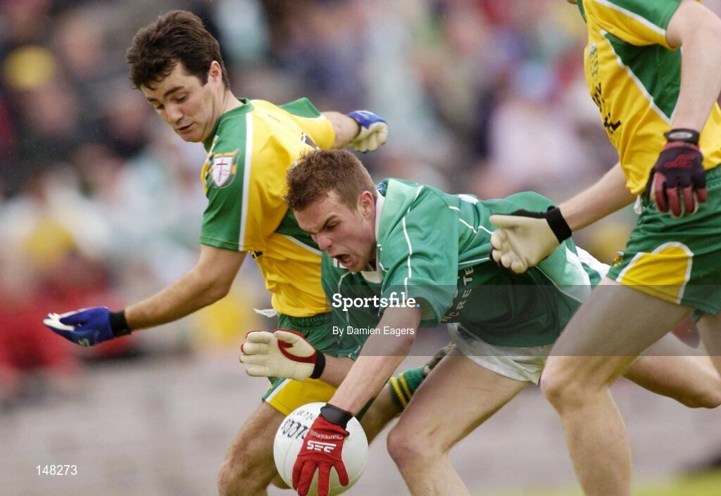 24 July 2004; Eamon Maguire, Fermanagh, is tackled by Niall McCready, Donegal. Bank of Ireland Senior Football Championship Qualifier, Round 4, Fermanagh v Donegal, Tighernach's Park, Clones. Co. Monaghan. Picture credit; Damien Eagers / SPORTSFILE