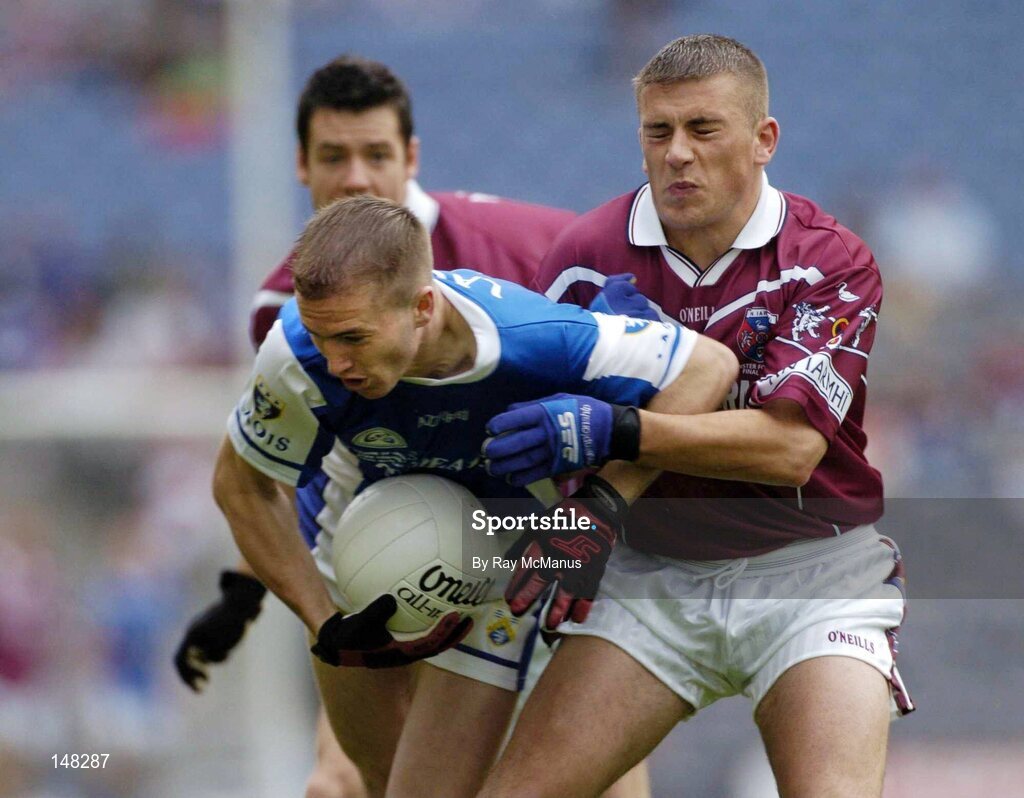 24 July 2004; Joe Higgins, Laois, attempts to clear under pressure from Westmeath's Alan Mangan, right, and Brian Morley. Bank of Ireland Leinster Senior Football Championship Final Replay, Westmeath v Laois, Croke Park, Dublin. Picture credit; Ray McManus / SPORTSFILE
