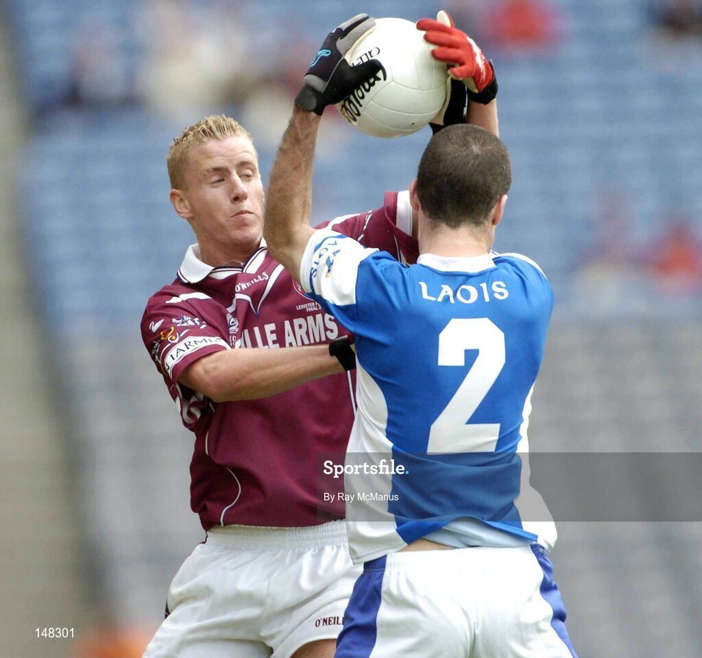 24 July 2004; Denis Glennon, Westmeath, is tackled by Aidan Fennelly, Laois. Bank of Ireland Leinster Senior Football Championship Final Replay, Westmeath v Laois, Croke Park, Dublin. Picture credit; Ray McManus / SPORTSFILE