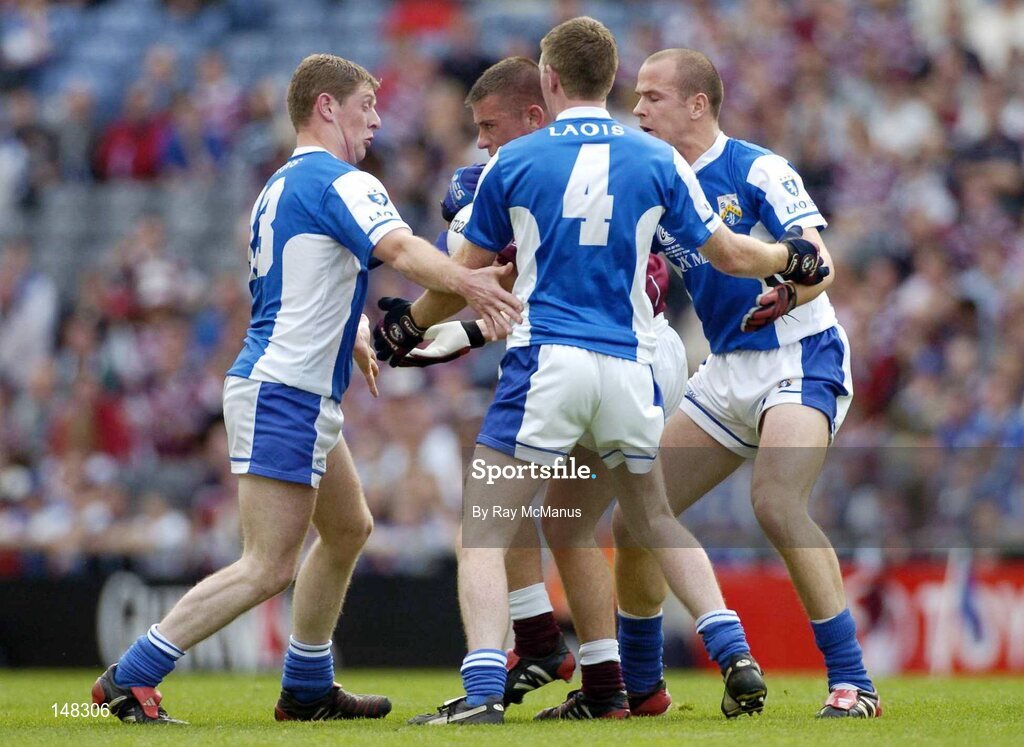 24 July 2004; Alan Mangan, Westmeath, is tackled by Laois players Brian McDonald, left, Paul McDonald (4), and Tom Kelly. Bank of Ireland Leinster Senior Football Championship Final Replay, Westmeath v Laois, Croke Park, Dublin. Picture credit; Ray McManus / SPORTSFILE