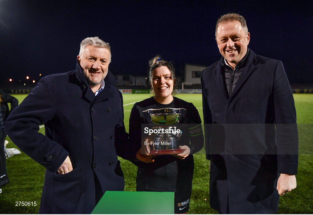 2 March 2024; Laurie Ryan of Athlone Town is presented with the President's Cup by FAI President Paul Cooke, left, and Minister of State for Sport and Physical Education Thomas Byrne TD after the 2024 Women's President's Cup match between Athlone Town and Peamount United at Athlone Town Stadium in Athlone, Westmeath. Photo by Tyler Miller/Sportsfile