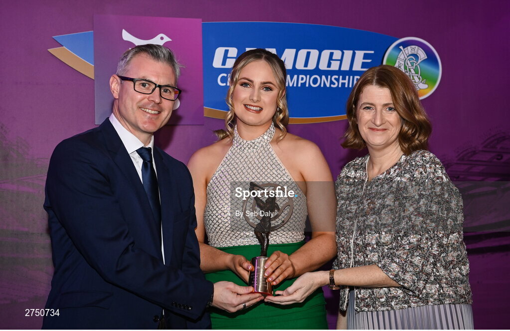 2 March 2024; Maria Cooney of Sarsfields, Galway, centre, is presented with her 2023 Team of the Year award by Uachtarán an Cumann Camógaíochta, Hilda Breslin and Chief Marketing Officer of AIB, Mark Doyle during the AIB Camogie Club Player Awards at Croke Park in Dublin. The awards recognise the top performing players throughout the AIB Camogie Club Championships and celebrate their hard work, commitment, and individual achievements from the 2023 season. Photo by Seb Daly/Sportsfile