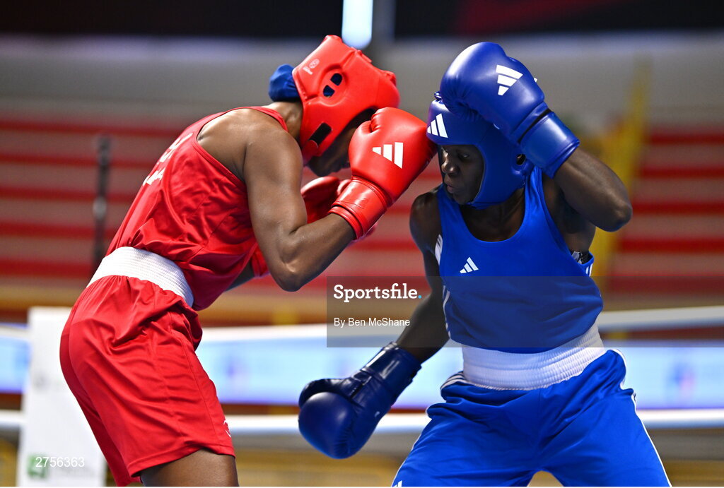 8 March 2024; Ivanusa Moreira of Cabo Verde, left, in action against Emily Tinah Nakalema of Uganda during their Women's 66kg Round of 32 bout during day six at the Paris 2024 Olympic Boxing Qualification Tournament at E-Work Arena in Busto Arsizio, Italy. Photo by Ben McShane/Sportsfile