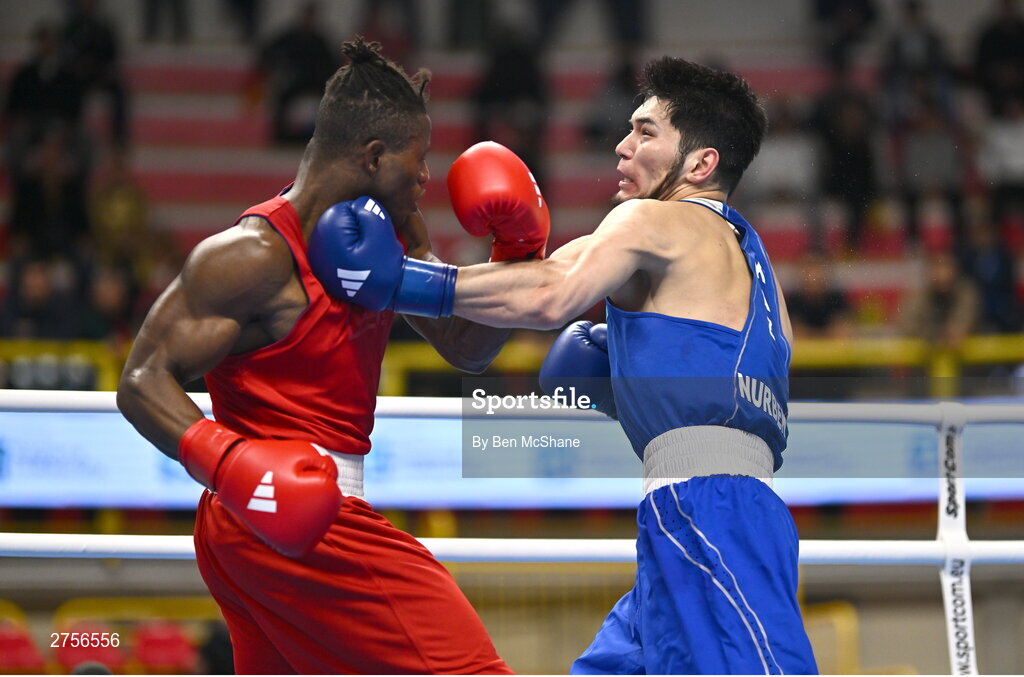 8 March 2024; Prewa Padabadi of Togo, left, in action against Nurbek Oralbay of Kazakhstan during their Men's 80kg Round of 32 bout during day six at the Paris 2024 Olympic Boxing Qualification Tournament at E-Work Arena in Busto Arsizio, Italy. Photo by Ben McShane/Sportsfile