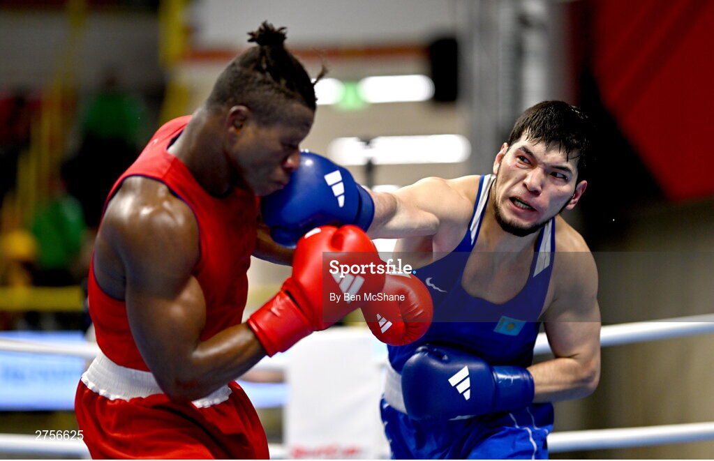 8 March 2024; Prewa Padabadi of Togo, left, in action against Nurbek Oralbay of Kazakhstan during their Men's 80kg Round of 32 bout during day six at the Paris 2024 Olympic Boxing Qualification Tournament at E-Work Arena in Busto Arsizio, Italy. Photo by Ben McShane/Sportsfile