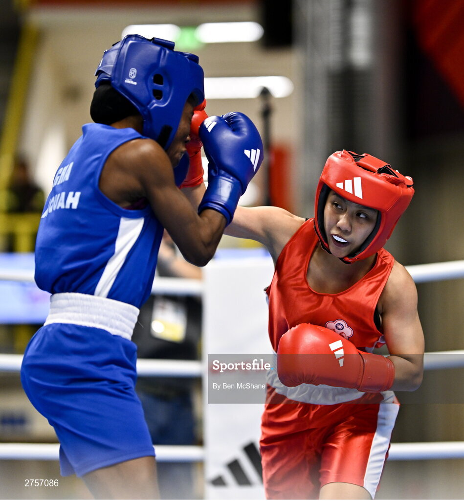 8 March 2024; Yi-Xuan Guo of Chinese Taipei, right, in action against Janet Acquah of Ghana during their Women's 50kg Round of 32 bout during day six at the Paris 2024 Olympic Boxing Qualification Tournament at E-Work Arena in Busto Arsizio, Italy. Photo by Ben McShane/Sportsfile