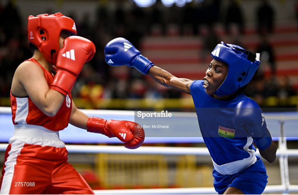 8 March 2024; Yi-Xuan Guo of Chinese Taipei, left, in action against Janet Acquah of Ghana during their Women's 50kg Round of 32 bout during day six at the Paris 2024 Olympic Boxing Qualification Tournament at E-Work Arena in Busto Arsizio, Italy. Photo by Ben McShane/Sportsfile