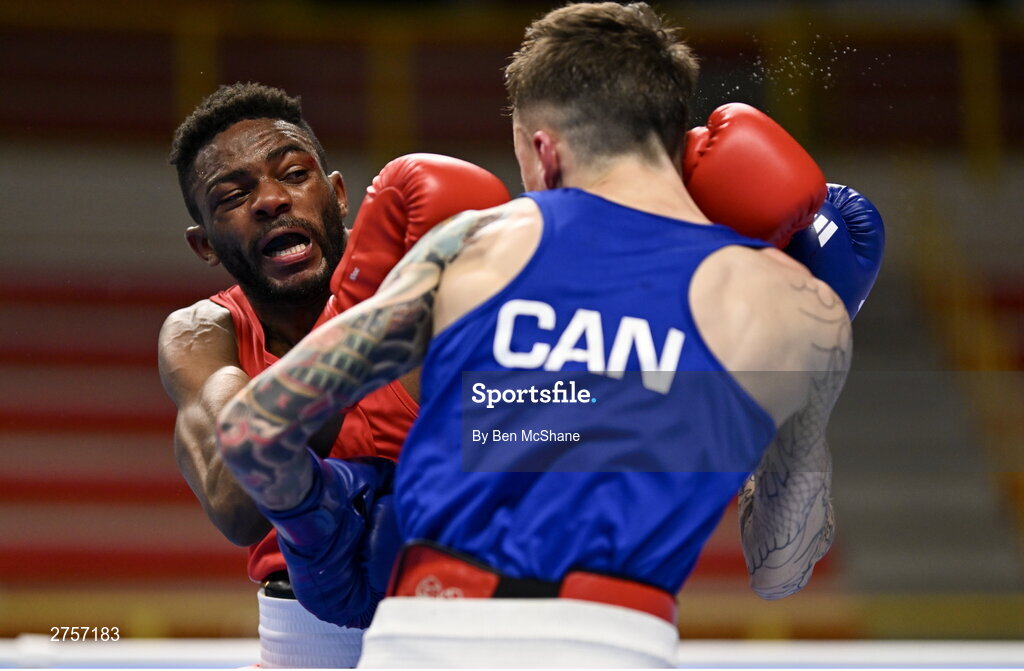 8 March 2024; Pedro Manuel Gomes of Angola, left, in action against Victor Tremblay of Canada during their Men's 57kg Round of 32 bout during day six at the Paris 2024 Olympic Boxing Qualification Tournament at E-Work Arena in Busto Arsizio, Italy. Photo by Ben McShane/Sportsfile
