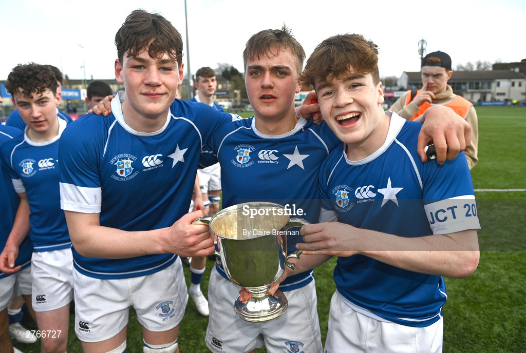 20 March 2024; James Whitty, left, Eoghan Brady, and Nic Sheehan of St Mary’s College lift the cup after the Bank of Ireland Leinster Schools Junior Cup final match between St Mary's College and Terenure College at Energia Park in Dublin. Photo by Daire Brennan/Sportsfile