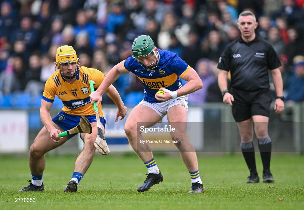 24 March 2024; Robert Byrne of Tipperary in action against Mark Rodgers of Clare during the Allianz Hurling League Division 1 semi-final match between Clare and Tipperary at Laois Hire O'Moore Park in Portlaoise, Laois. Photo by Piaras Ó Mídheach/Sportsfile