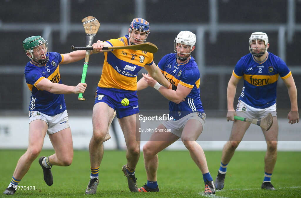 24 March 2024; David Fitzgerald of Clare is tackled by Tipperary players, Robert Byrne, left and Michael Breen during the Allianz Hurling League Division 1 semi-final match between Clare and Tipperary at Laois Hire O'Moore Park in Portlaoise, Laois. Photo by John Sheridan/Sportsfile