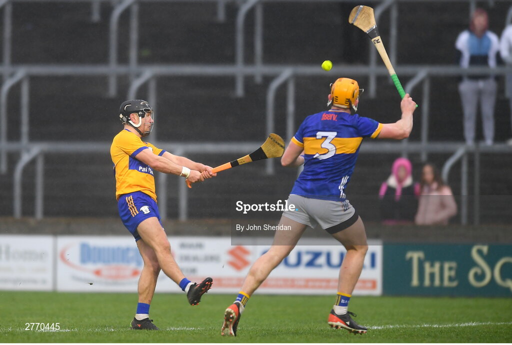 24 March 2024; David Reidy of Clare scores a point despite the efforts of Ronan Maher of Tipperary during the Allianz Hurling League Division 1 semi-final match between Clare and Tipperary at Laois Hire O'Moore Park in Portlaoise, Laois. Photo by John Sheridan/Sportsfile