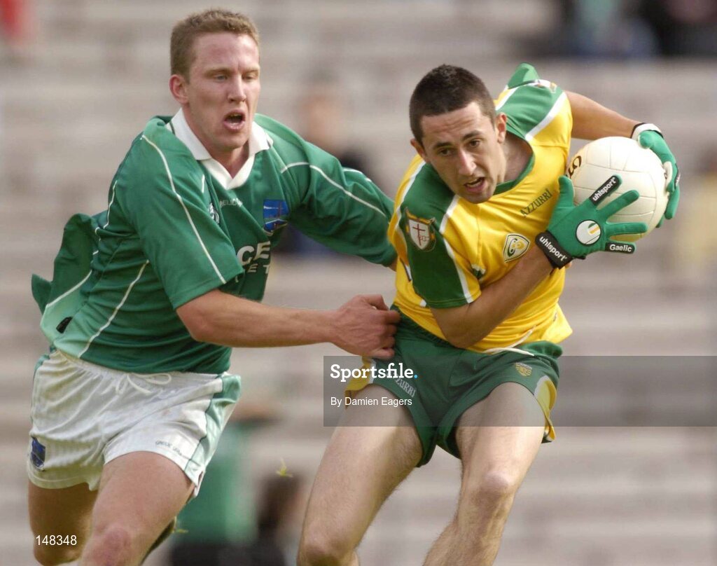 24 July 2004; Rory Kavanagh, Donegal, is tackled by Fermanagh's Shane McDermott. Bank of Ireland Senior Football Championship Qualifier, Round 4, Fermanagh v Donegal, Tighernach's Park, Clones. Co. Monaghan. Picture credit; Damien Eagers / SPORTSFILE