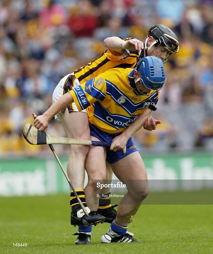 25 July 2004; Andrew Quinn, Clare, is tackled by Kilkenny's Peter Barry. Guinness All-Ireland Senior Hurling Championship, Quarter Final, Clare v Kilkkenny, Croke Park, Dublin. Picture credit; Ray McManus / SPORTSFILE