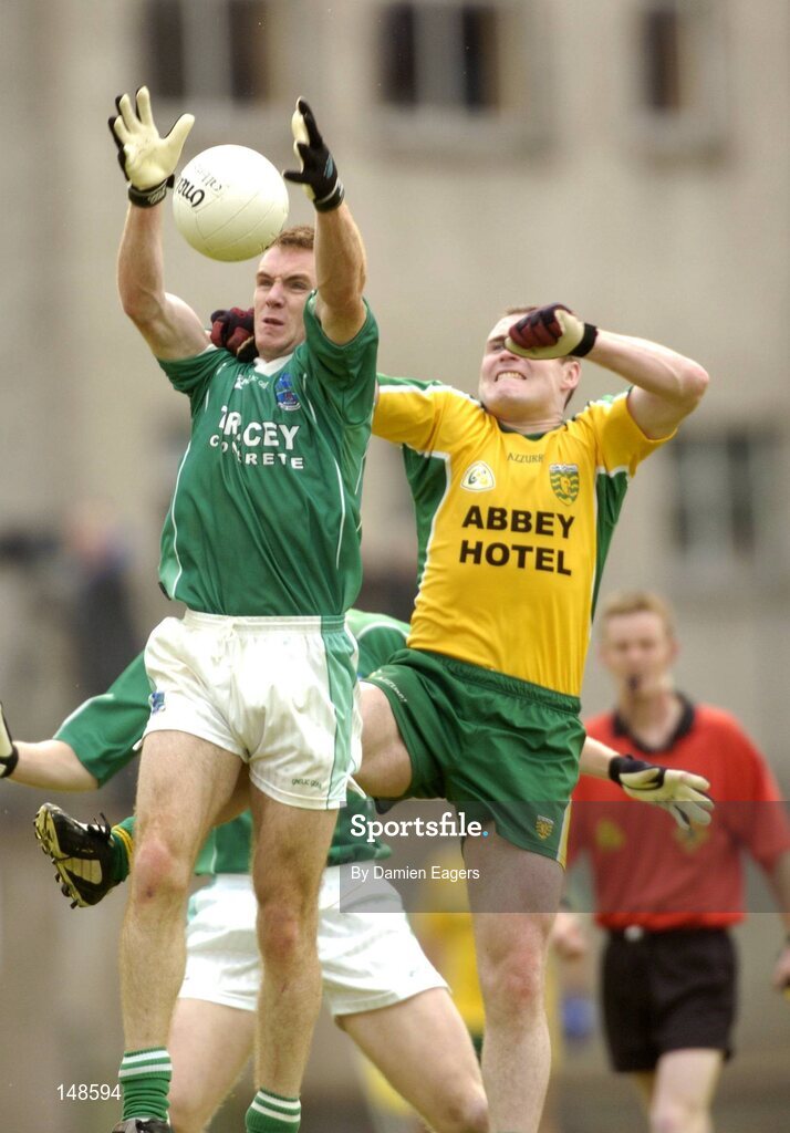 24 July 2004; Martin McGrath, Fermanagh, goes up for a high ball with Donegal's Adrian Sweeney. Bank of Ireland Senior Football Championship Qualifier, Round 4, Fermanagh v Donegal, Tighernach's Park, Clones. Co. Monaghan. Picture credit; Damien Eagers / SPORTSFILE