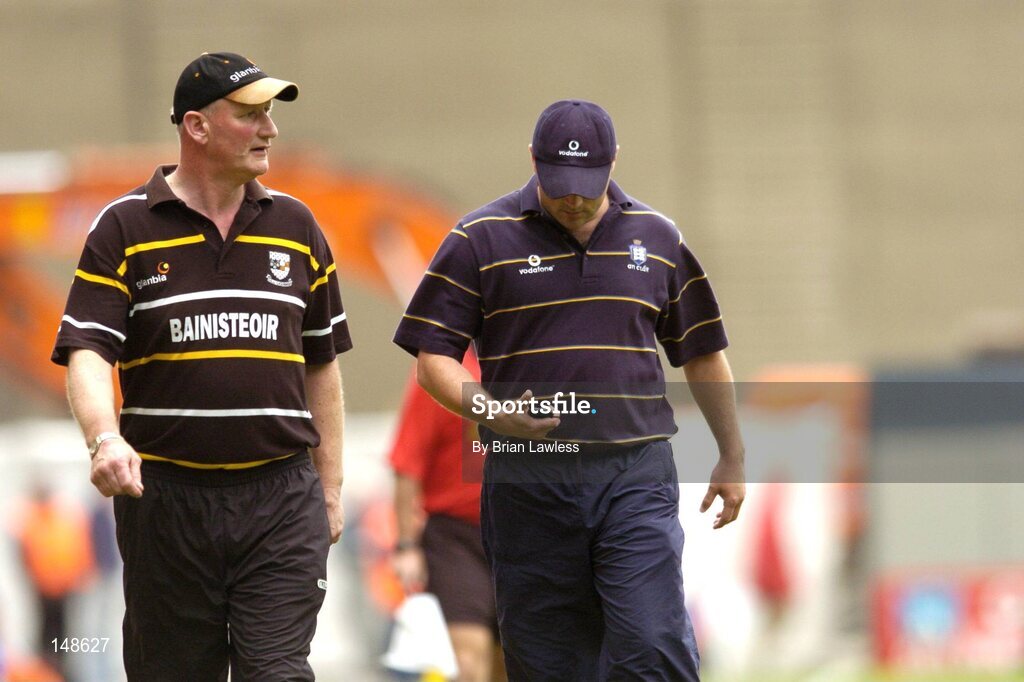 25 July 2004; Kilkenny manager Brian Cody keeps an eye on the game as Clare manager Anthony Daly checks his watch. Guinness All-Ireland Senior Hurling Championship, Quarter Final, Clare v Kilkenny, Croke Park, Dublin. Picture credit; Brian Lawless / SPORTSFILE