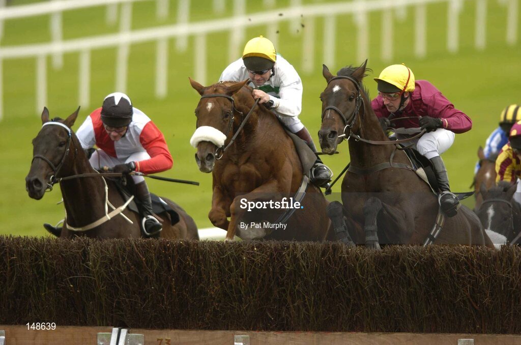 27 July 2004; Eventual winner Talking Cents with Mick Fitzgerald up, jumps the last behind Eskimo Jack with Conor O'Dwyer up, centre, and Quinze, Jim Culloty, right, on their way to winning the Albatros Plant Nutrition Steeplechase. Galway Races, Ballybrit, Co. Galway. Picture credit; Pat Murphy / SPORTSFILE