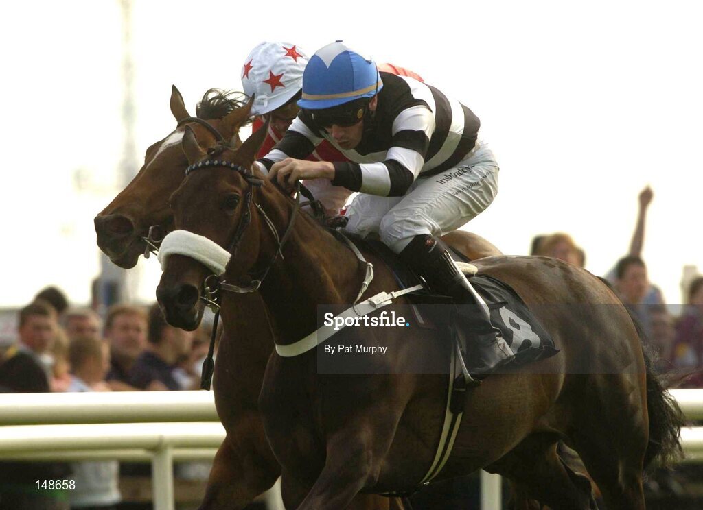 27 July 2004; Right Key, with Declan McDonogh up, races away from Faint Heart with Mick Kinane up, partially hidden, on their way to winning the McDonagh Feeds EBF Fillies Maiden. Galway Races, Ballybrit, Co. Galway. Picture credit; Pat Murphy / SPORTSFILE