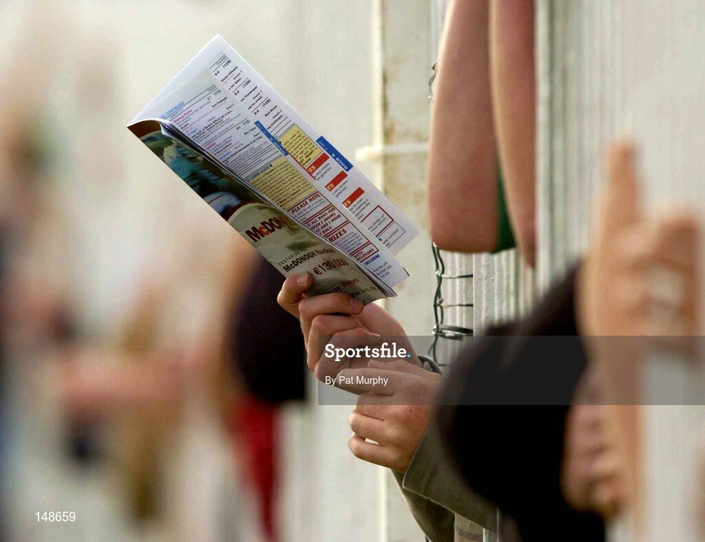 27 July 2004; A fan checks his race card during the McDonagh Feeds EBF Fillies Maiden. Galway Races, Ballybrit, Co. Galway. Picture credit; Pat Murphy / SPORTSFILE