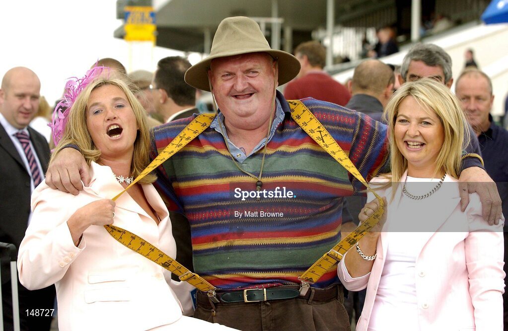 28 July 2004; Mick Lawlee, from Listowel, Co. Kerry, pictured with bookies Margo Ann Kelleher, left, and Harriet Murphy, from Cork, at the Galway Races, Ballybrit, Co. Galway. Picture credit; Matt Browne / SPORTSFILE