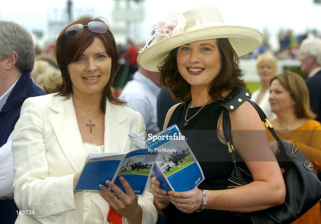 28 July 2004; Caroline Costello from Newmarket-on-Fergus, Co. Clare, left, and Avia Weir, from Stillorgan, Co. Dublin. enjoy a day out at the Galway Races. Galway Races, Ballybrit, Co. Galway. Picture credit; Pat Murphy / SPORTSFILE