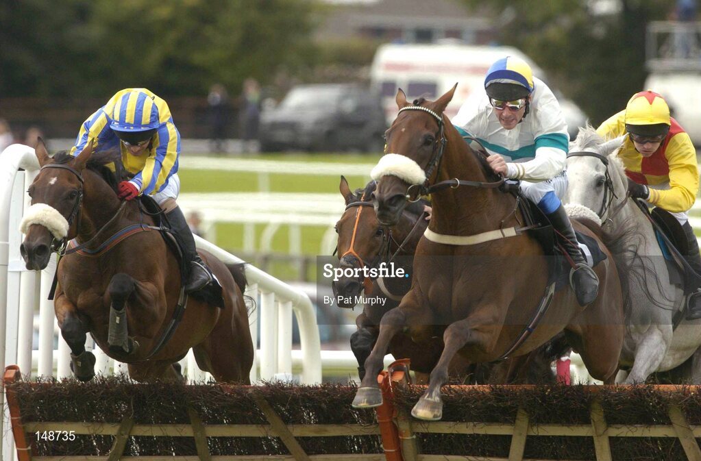 28 July 2004; Eventual winner Indemnity, with Tom Ryan up, jumps the last behind Rockstown Boy, with Davy Russell up, right, on their way to winning the HP Financial Services Hurdle. Galway Races, Ballybrit, Co. Galway. Picture credit; Pat Murphy / SPORTSFILE