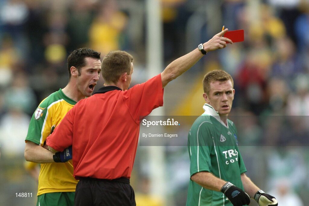 24 July 2004; Donegal's Brendan Devenney is issued the red card by referee Joe McQuillan as Fermanagh's Martin McGrath looks on. Bank of Ireland Senior Football Championship Qualifier, Round 4, Fermanagh v Donegal, Tighernach's Park, Clones. Co. Monaghan. Picture credit; Damien Eagers / SPORTSFILE