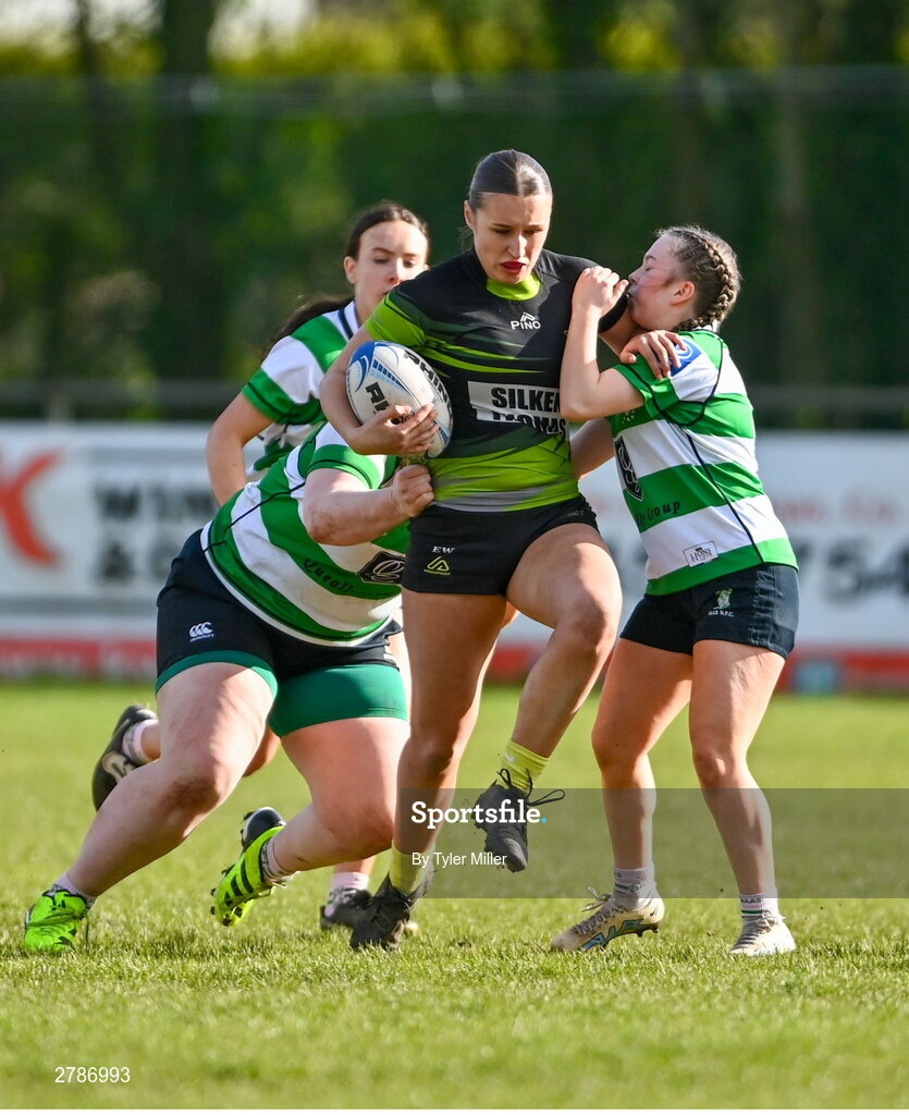 13 April 2024; Ellie White of Portdara is tackled by Rachel Clarke, left, and Muireann Cawley of Naas during the Leinster Rugby Girl's U18 semi-final match between Naas and Portdara at Naas RFC in Kildare. Photo by Tyler Miller/Sportsfile
