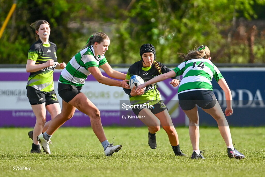 13 April 2024; Sarah Boyce Donohoe of Portdara is tackled by Sophie Francis, left, and Lily Haslam of Naas during the Leinster Rugby Girl's U18 semi-final match between Naas and Portdara at Naas RFC in Kildare. Photo by Tyler Miller/Sportsfile
