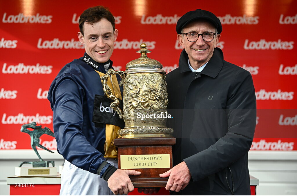 1 May 2024; Jockey JJ Slevin and trainer Martin Brassil with the Punchestown Gold Cup after sending out Fastorslow to win the Ladbrokes Punchestown Gold Cup during day two of the Punchestown Festival at Punchestown Racecourse in Kildare. Photo by Seb Daly/Sportsfile