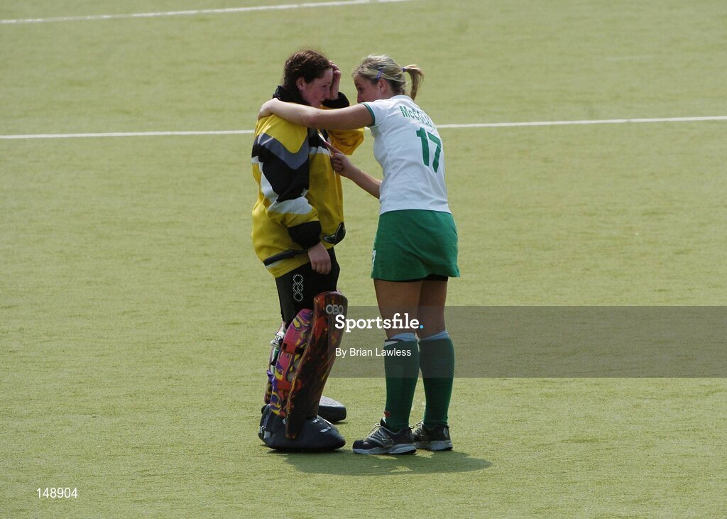 30 July 2004; Ireland's Kirsty McCollum (17) consoles her team-mate Alison Lappin after defeat to Belarus. European Hockey Junior Championship, Cross Over Match, Ireland v Belarus, UCD, Belfield, Dublin. Picture credit; Brian Lawless / SPORTSFILE
