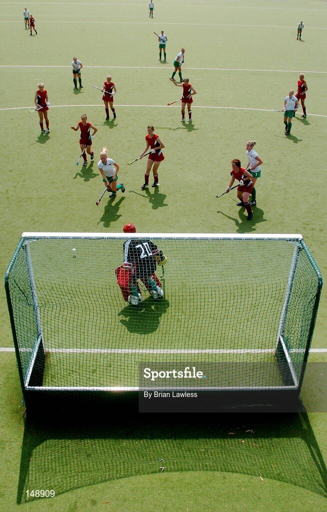 30 July 2004; Ireland and Belarus players watch as an Irish shot on goal goes wide. European Hockey Junior Championship, Cross Over Match, Ireland v Belarus, UCD, Belfield, Dublin. Picture credit; Brian Lawless / SPORTSFILE