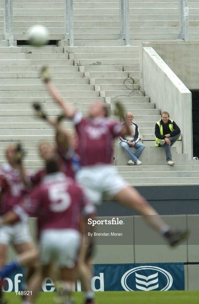 24 July 2004; Two construction workers watch the game from part of the reconstructed hill 16 end. Bank of Ireland Leinster Senior Football Championship Final Replay, Westmeath v Laois, Croke Park, Dublin. Picture credit; Brendan Moran / SPORTSFILE