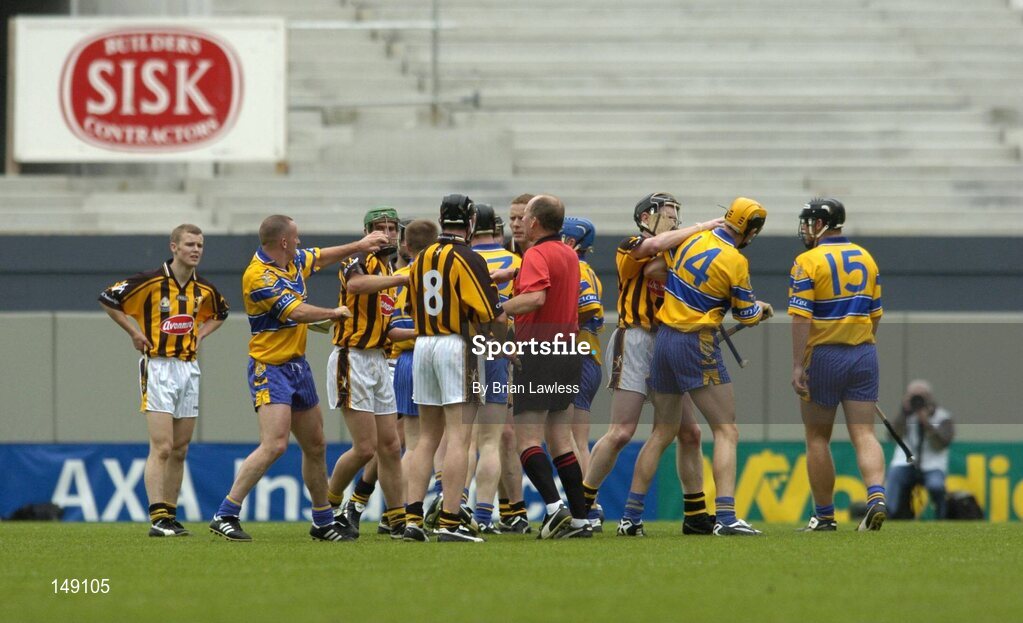 25 July 2004; Referee Ger Harrington attempts to intervene as Clare and Kilkenny players become involved in a tussle. Guinness All-Ireland Senior Hurling Championship, Quarter Final, Clare v Kilkenny, Croke Park, Dublin. Picture credit; Brian Lawless / SPORTSFILE