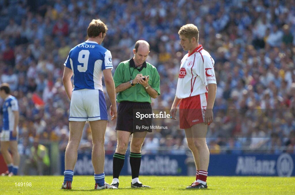 1 August 2004; Noel Garvan, Laois, and Kevin Hughes, Tyrone, are booked by referee Michael Collins. Bank of Ireland All-Ireland Football Championship, Round 4, Laois v Tyrone, Croke Park, Dublin. Picture credit; Ray McManus / SPORTSFILE