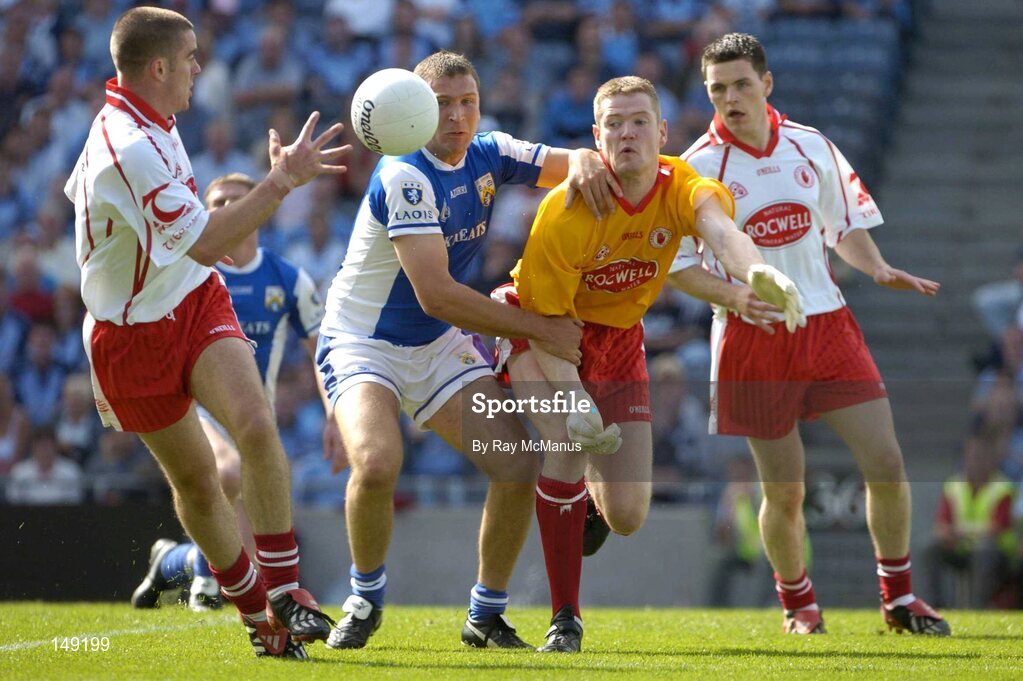 1 August 2004; Tyrone goalkeeper Pascal McConnell, supported by Conor Gormley, right, passes to Philip Jordan under pressure from Shane Cooke, Laois . Bank of Ireland All-Ireland Football Championship, Round 4, Laois v Tyrone, Croke Park, Dublin. Picture credit; Ray McManus / SPORTSFILE