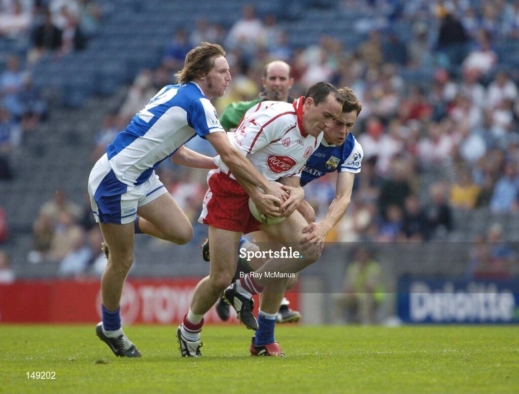 1 August 2004; Brian Dooher, Tyrone, is tackled by Laois players Colm Parkinson, left, and Padraig McMahon. Bank of Ireland All-Ireland Football Championship, Round 4, Laois v Tyrone, Croke Park, Dublin. Picture credit; Ray McManus / SPORTSFILE