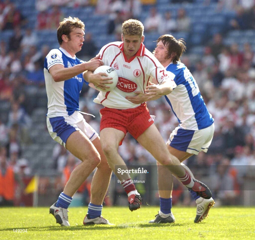 1 August 2004; Kevin Hughes, Tyrone, is tackled by Laois players Noel Garvan, left, and Colm Parkinson. Bank of Ireland All-Ireland Football Championship, Round 4, Laois v Tyrone, Croke Park, Dublin. Picture credit; Ray McManus / SPORTSFILE