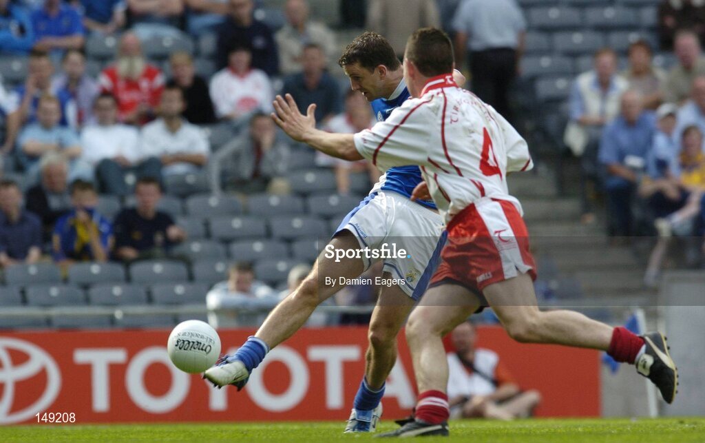 1 August 2004; Kevin Fitzpatrick, Laois, scores his sides second goal despite the challenge of Ryan McMenamin, Tyrone. Bank of Ireland All-Ireland Football Championship, Round 4, Laois v Tyrone, Croke Park, Dublin. Picture credit; Damien Eagers / SPORTSFILE