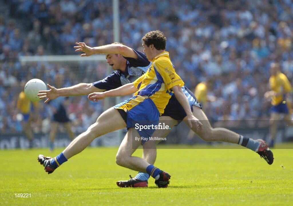 1 August 2004; Stephen Lohan, Roscommon, clears under pressiure from Dublin's Darren Magee. Dublin. Bank of Ireland All-Ireland Football Championship, Round 4, Dublin v Roscommon, Croke Park, Dublin. Picture credit; Ray McManus / SPORTSFILE