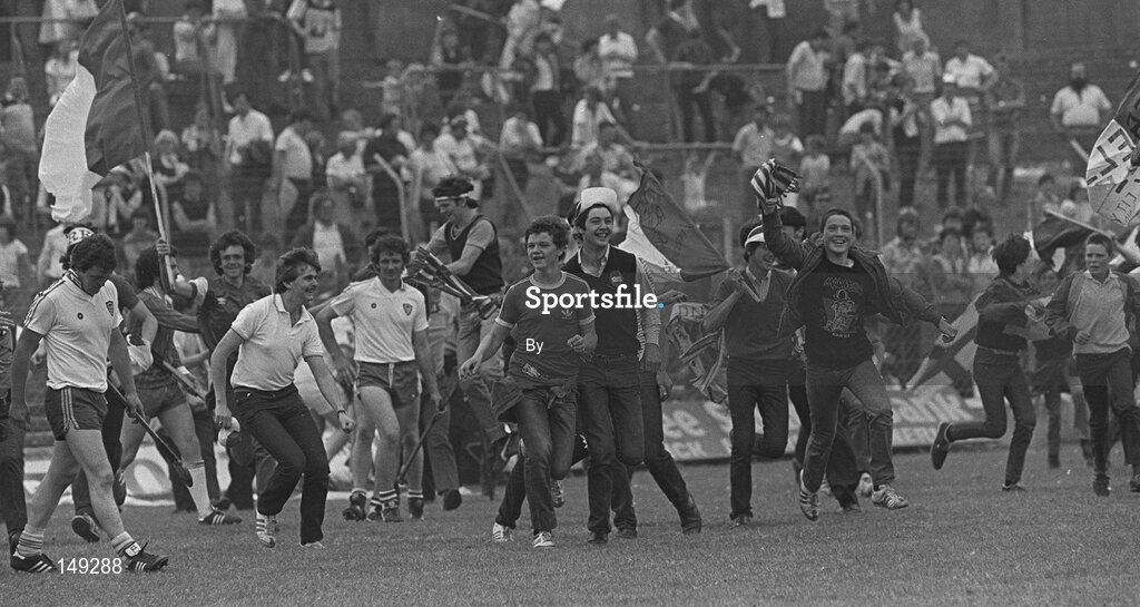 10 July 1983; Cork supporters run onto the pitch to celebrate victory as Waterford captain Seamus Hannon, (centre) and team-mate Kieran Ryan look on. Munster hurling Final. Cork v Waterford, Gaelic Grounds, Limerick. Picture credit; Ray McManus / SPORTSFILE