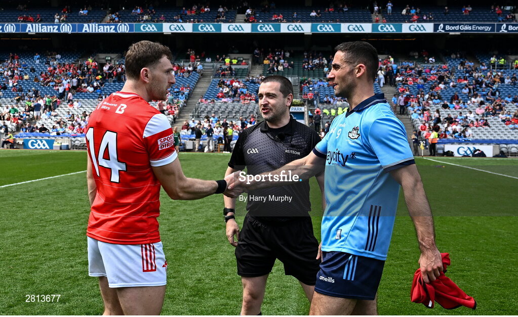 12 May 2024; Captains Sam Mulroy of Louth and James McCarthy of Dublin shake hands across referee Noel Mooney before the Leinster GAA Football Senior Championship final match between Dublin and Louth at Croke Park in Dublin. Photo by Harry Murphy/Sportsfile