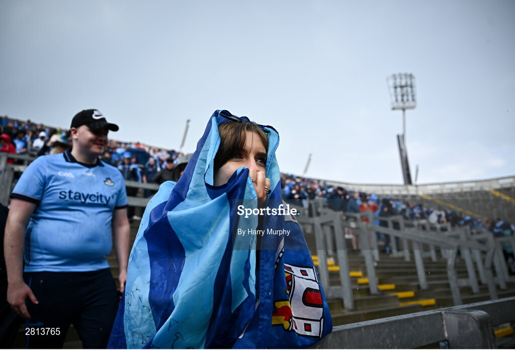 12 May 2024; Dublin supporter Ciara Jordan uses a flag to cover from the rain the Leinster GAA Football Senior Championship final match between Dublin and Louth at Croke Park in Dublin. Photo by Harry Murphy/Sportsfile