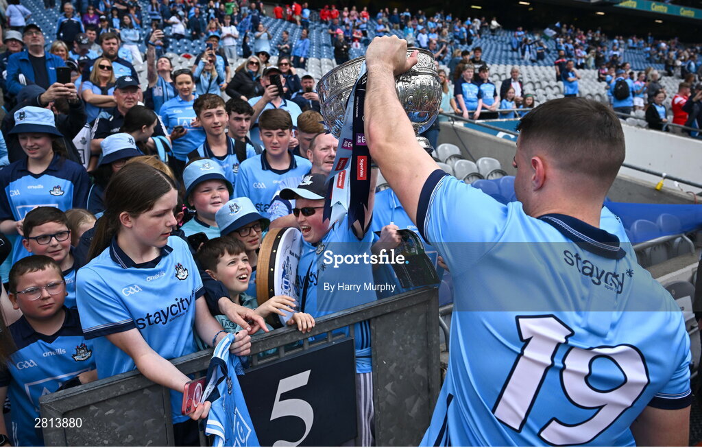 12 May 2024; Brian Howard of Dublin shows the Delaney Cup to supporters after his side's victory in the Leinster GAA Football Senior Championship final match between Dublin and Louth at Croke Park in Dublin. Photo by Harry Murphy/Sportsfile